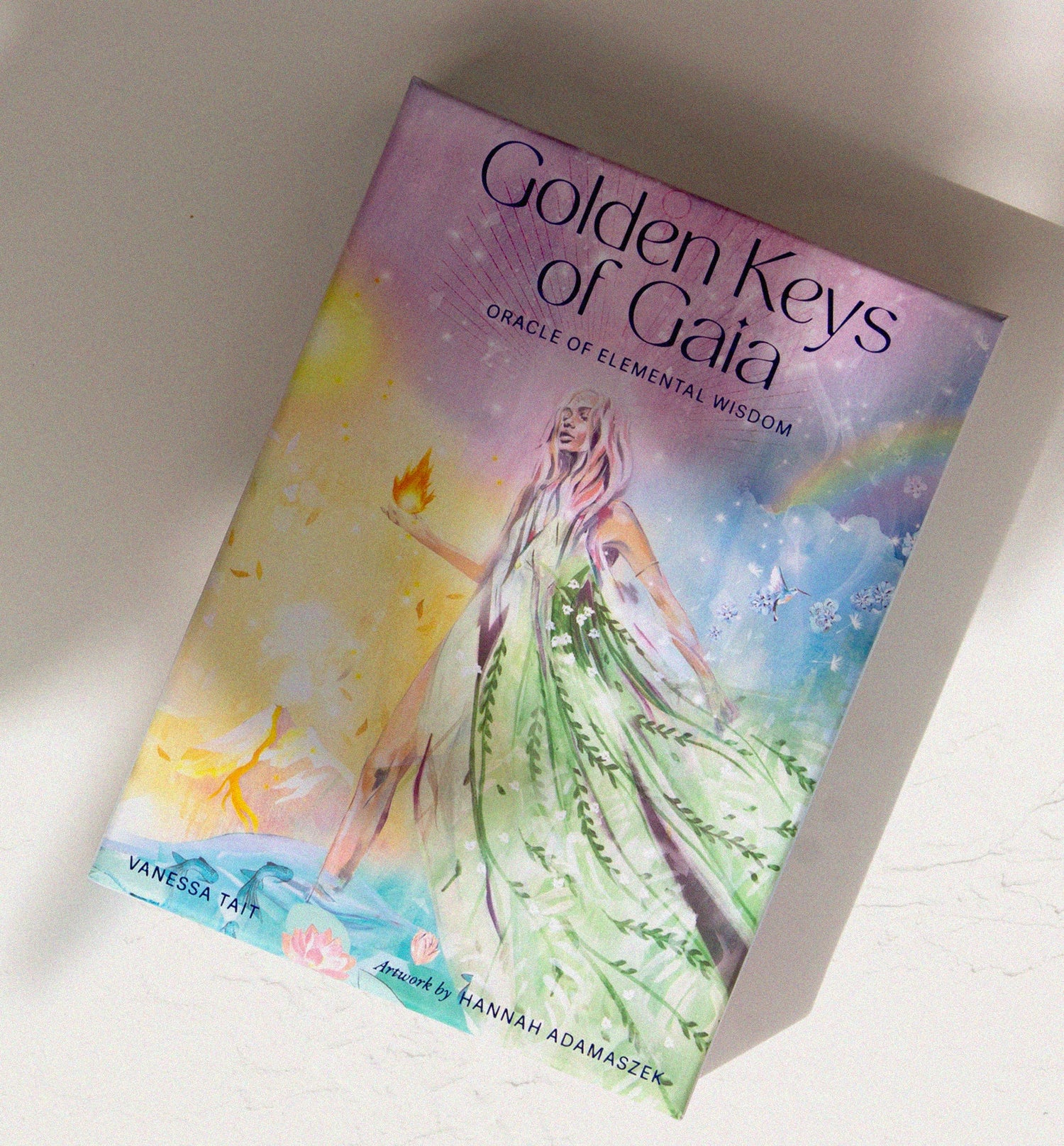 Golden Keys of Gaia oracle card deck featuring illustrated box artwork with a female figure and elemental symbolism.