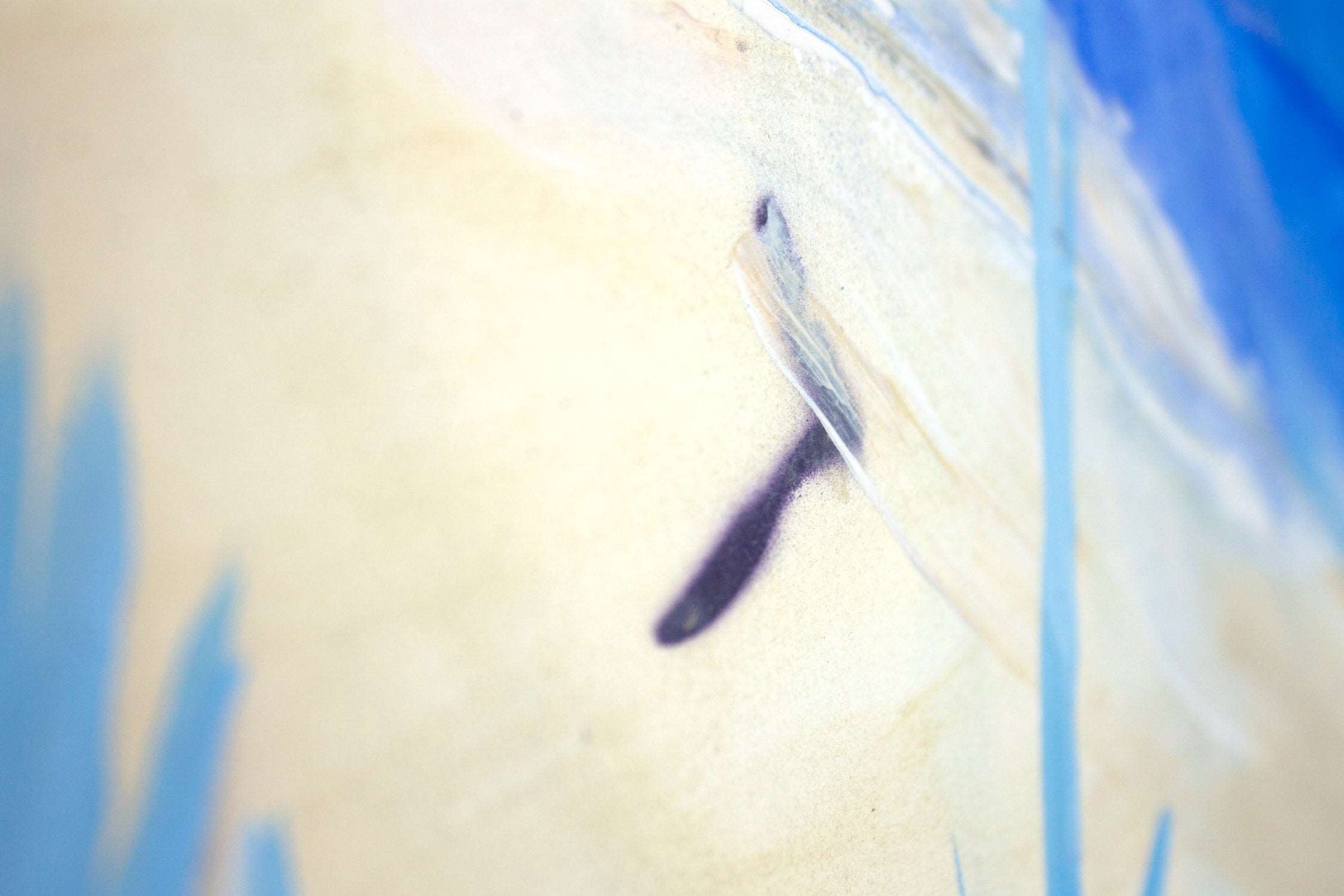 Close up detail of painting Between Sea & Sky of a figure walking across the sandy beach.