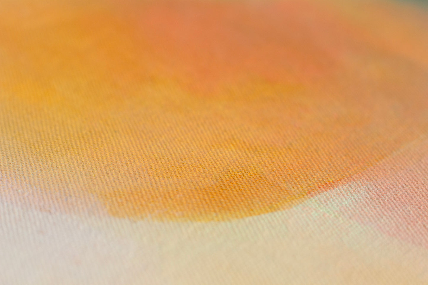 Close-up of abstract orange painting with textured canvas, warm citrus tones and soft blended colour.