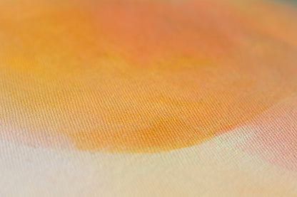 Close-up of abstract orange painting with textured canvas, warm citrus tones and soft blended colour.