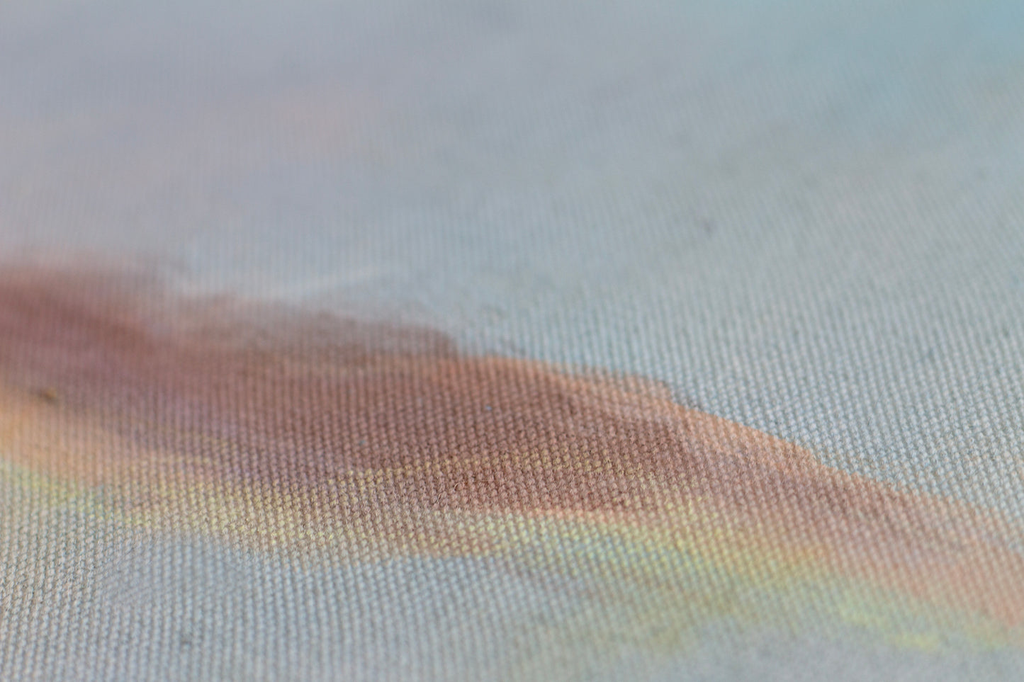Detail of sunset painting with textured canvas, soft blue and warm golden tones, abstract landscape wall art.