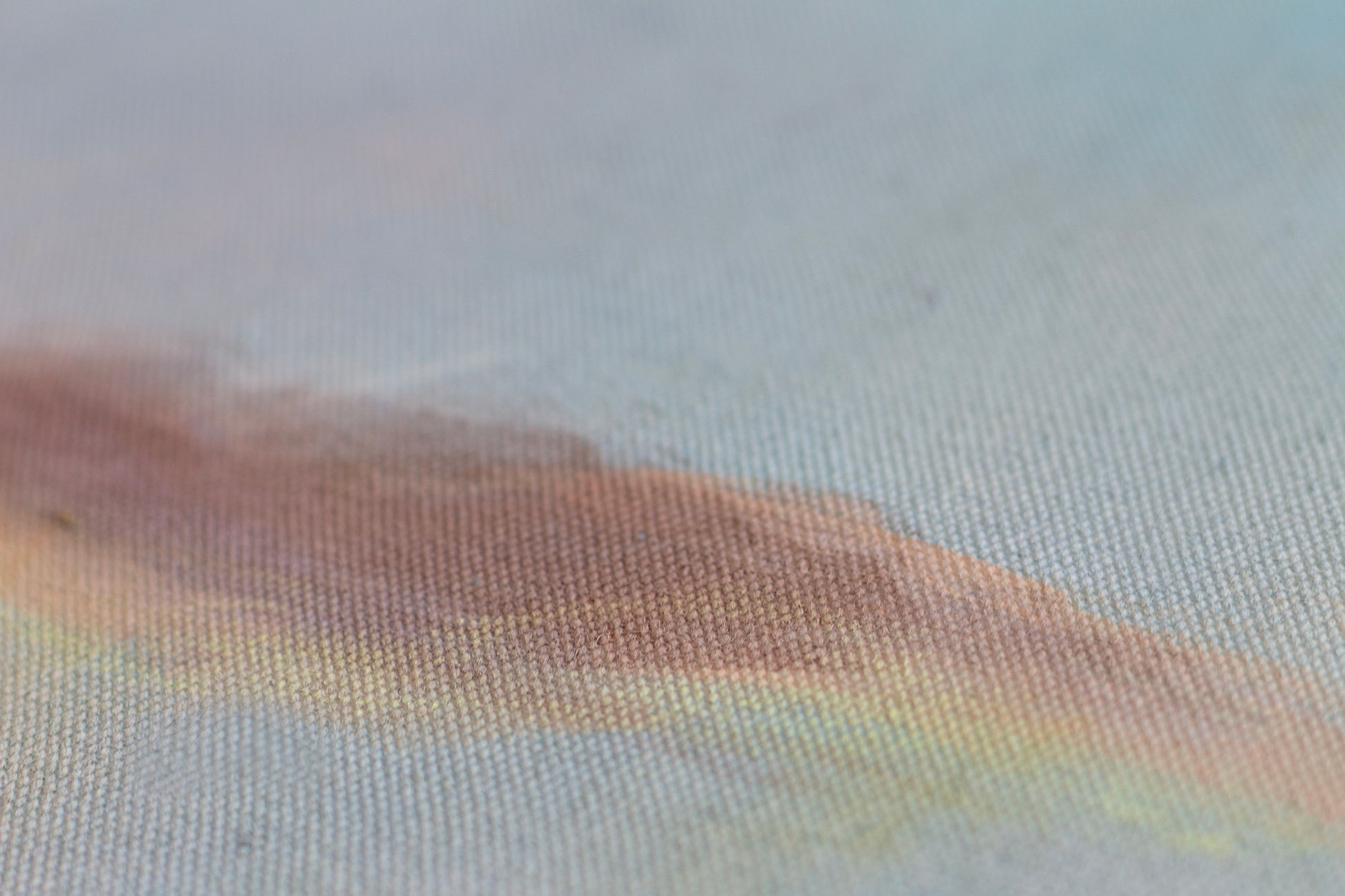 Detail of sunset painting with textured canvas, soft blue and warm golden tones, abstract landscape wall art.