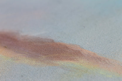 Detail of sunset painting with textured canvas, soft blue and warm golden tones, abstract landscape wall art.