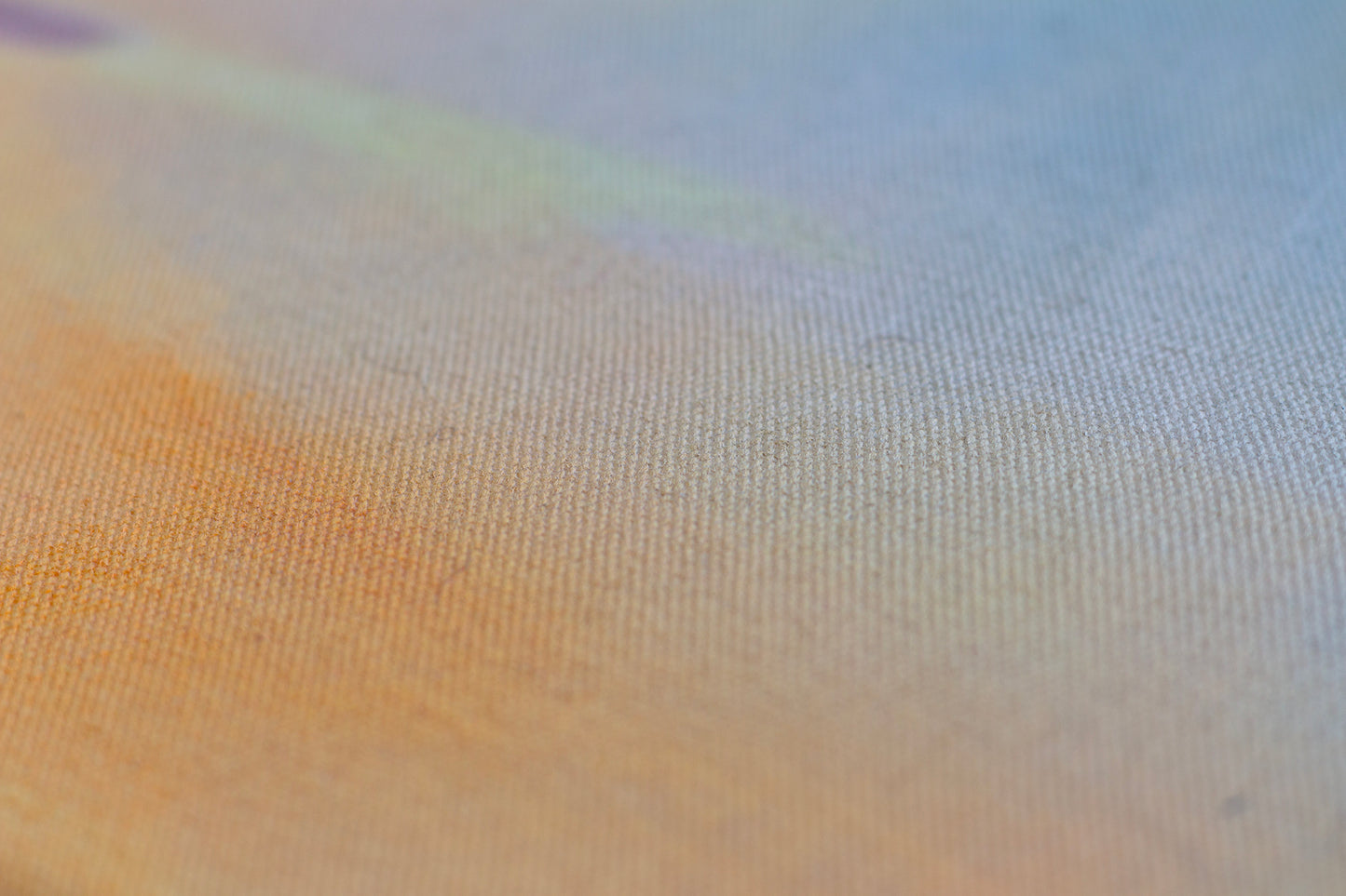 Detail of sunset painting with textured canvas, soft blue sky and warm golden tones, abstract landscape art.