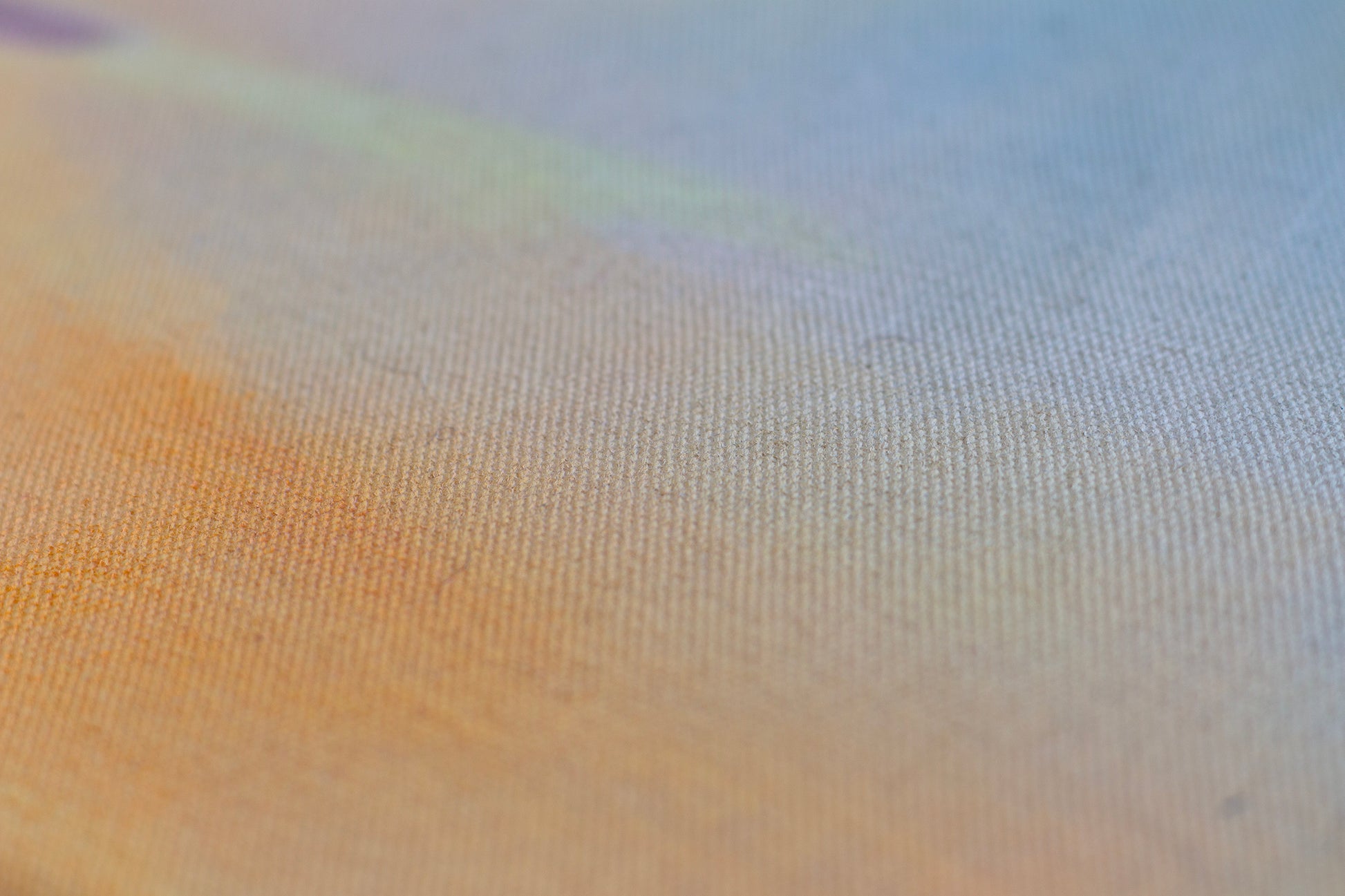 Detail of sunset painting with textured canvas, soft blue sky and warm golden tones, abstract landscape art.