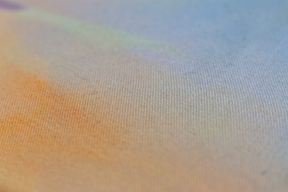 Detail of sunset painting with textured canvas, soft blue sky and warm golden tones, abstract landscape art.