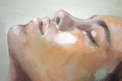 Close-up detail of Mediterranean Musing, a painting by Hannah Adamaszek, showing a woman's serene face with closed eyes, softly illuminated with delicate brushstrokes. The textured canvas and subtle color blending highlight the peaceful and meditative essence of the artwork.
