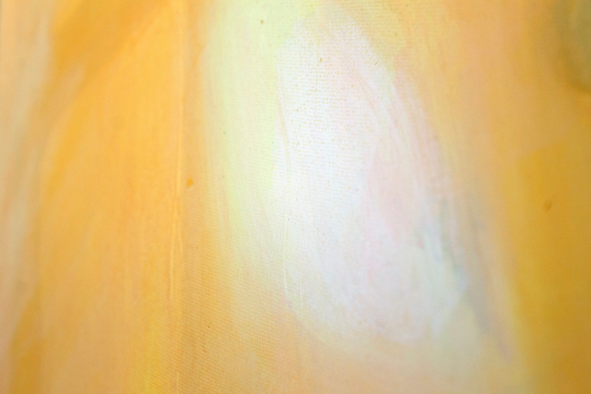 Close up art detail with the texture of the canvas and paint. Orange leading to a white glow.