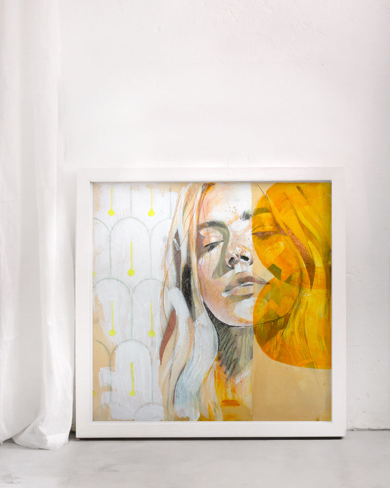 Warm and bright art print of a woman portrait. Mediterranean tiles are in the background. Framed in a white frame in on a white background.  Mallorca style interior.