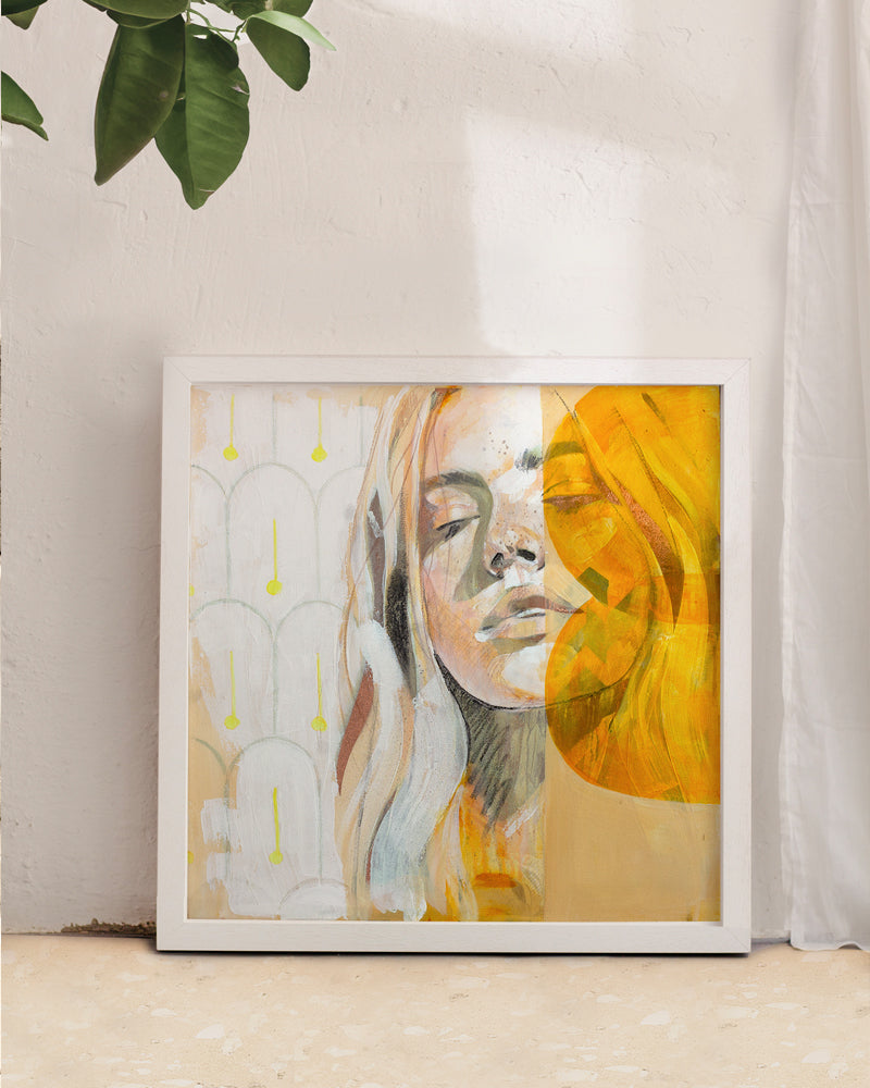 Orange and yellow portrait print set in a Mallorca interior with orange tree leaves with a white curtain.