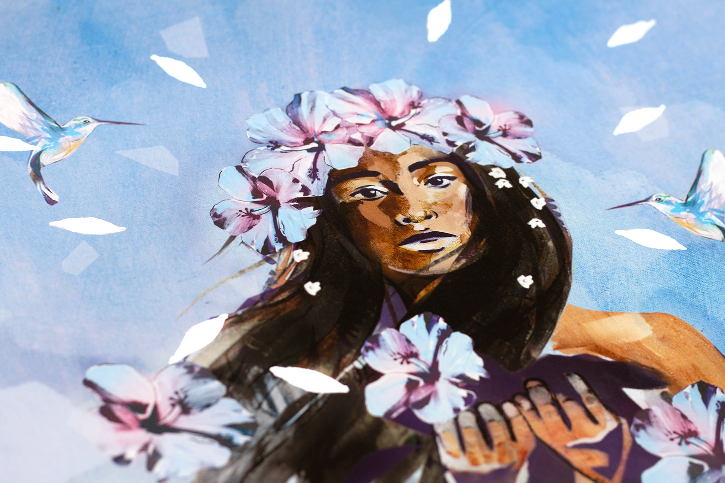 Close-up detail of the Forgiveness art print showing a woman with floral crown, hummingbirds, and silver leaf accents against a soft blue sky, symbolising healing, compassion, and emotional release