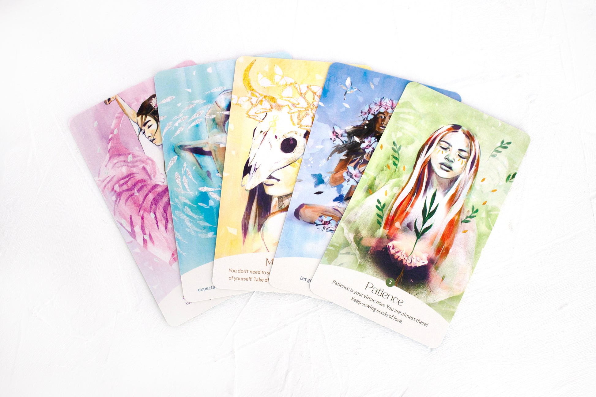 Spread of Golden Keys of Gaia oracle cards featuring feminine, nature-inspired elemental artwork and spiritual messages