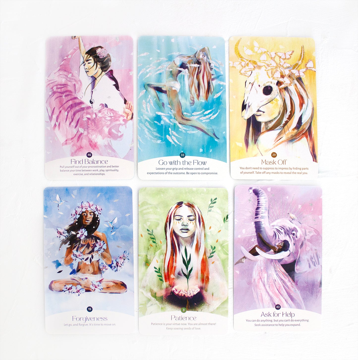 Selection of oracle cards from the Golden Keys of Gaia deck featuring feminine, nature-inspired artwork and themes of balance, flow, patience, forgiveness, and support