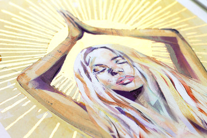 Close-up detail of the Shine Bright art print, showing hand-applied gold leaf radiating around a painted female figure, symbolising light and inner fire.