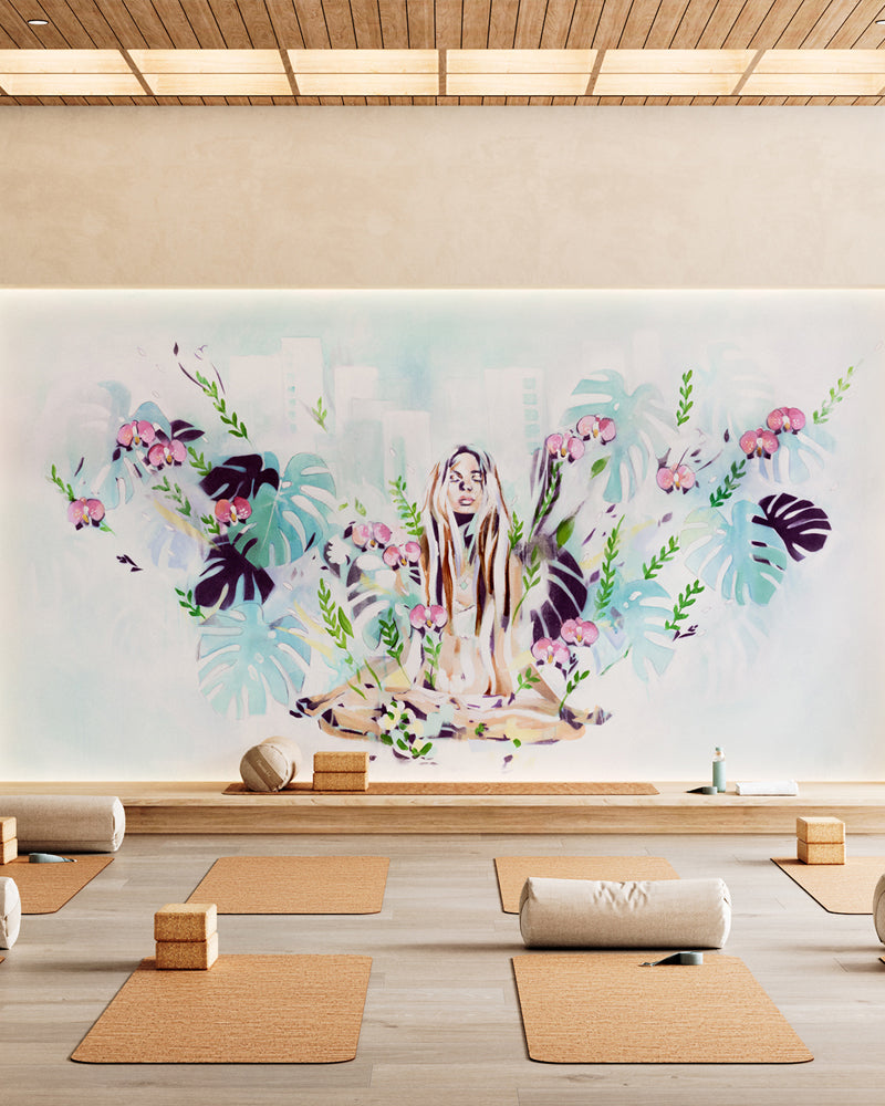 In the Fields wallpaper mural by Hannah Chloe in a yoga studio, featuring a meditating woman surrounded by hand-painted leaves and flowers, creating a calming, nature-inspired wall art design.